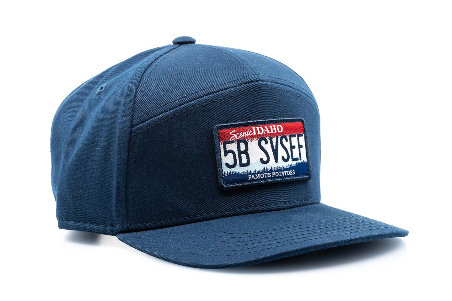 a blue baseball cap with an idaho license plate with "5B SVSEF" stitched on it