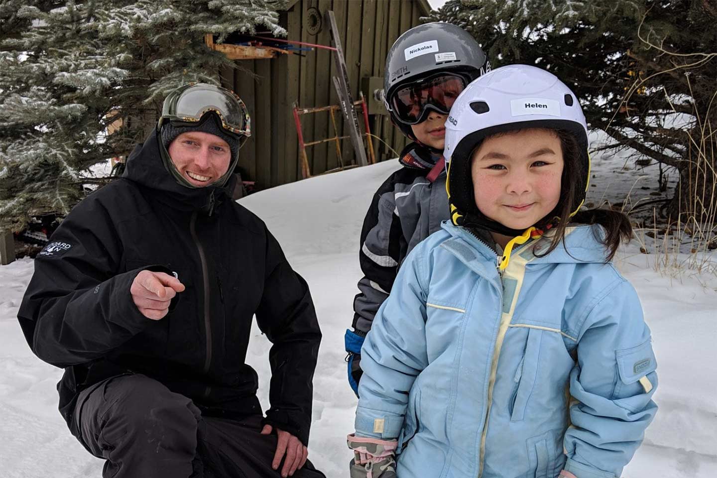 Snowboard coach with two kids